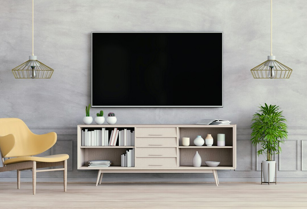 Black flat screen TV turned on on a wooden rack